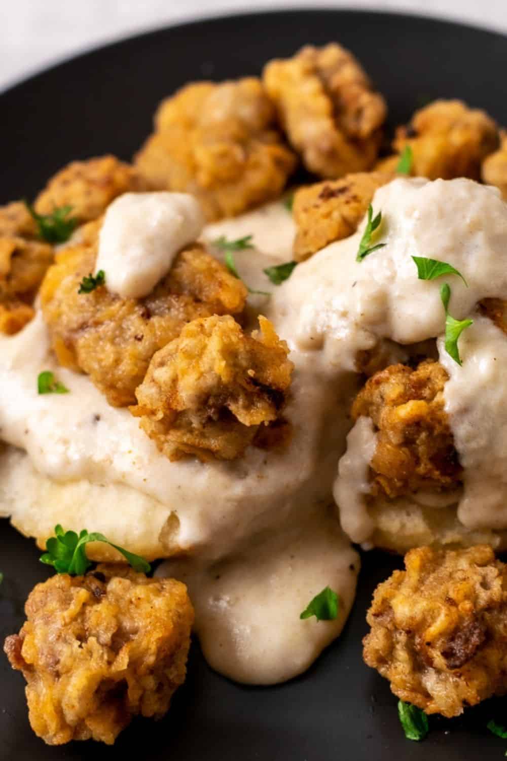 Chicken Fried Steak Bites and Pepper Gravy with Homemade Biscuits on a plate.