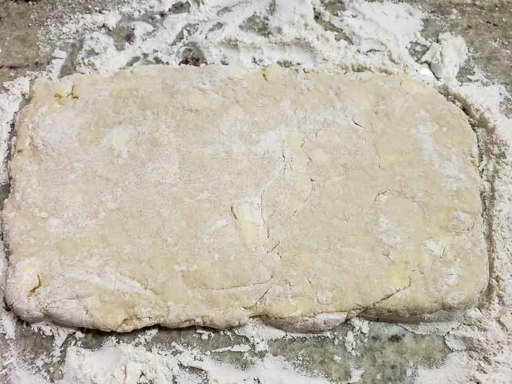 buttermilk biscuit dough rolled into a rectangle.