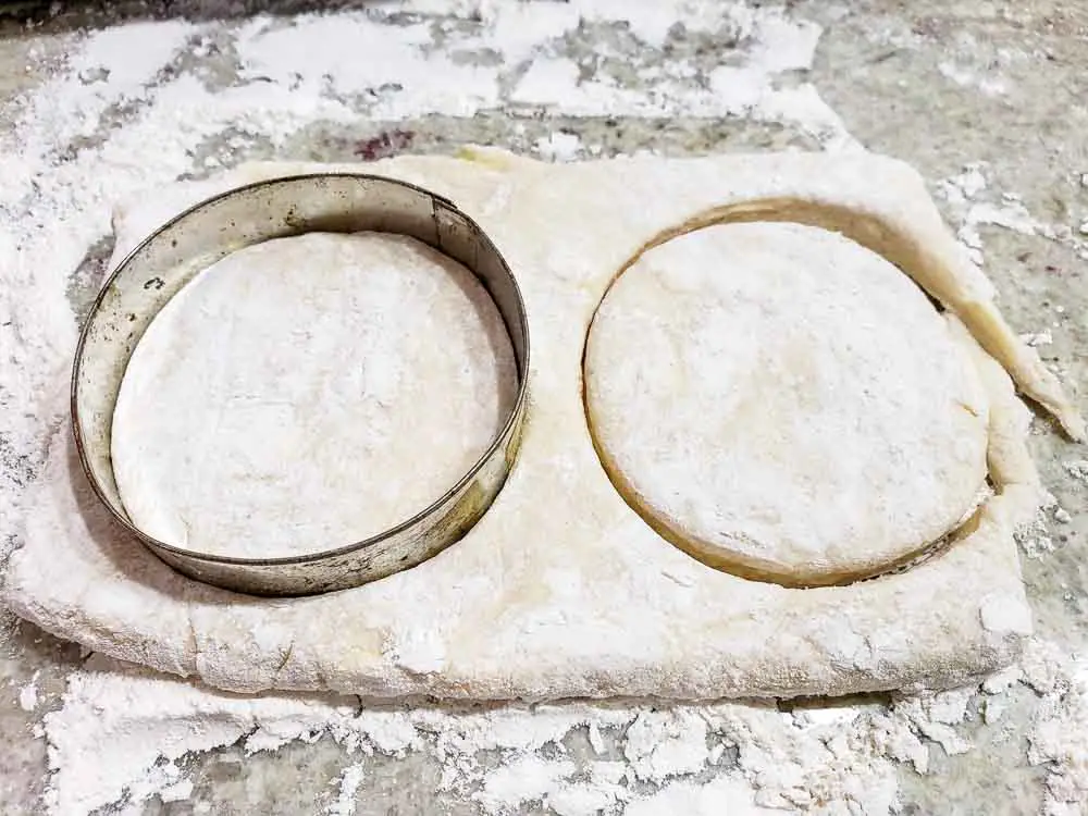 round biscuit cutter cutting out Small Batch Buttermilk Biscuits.