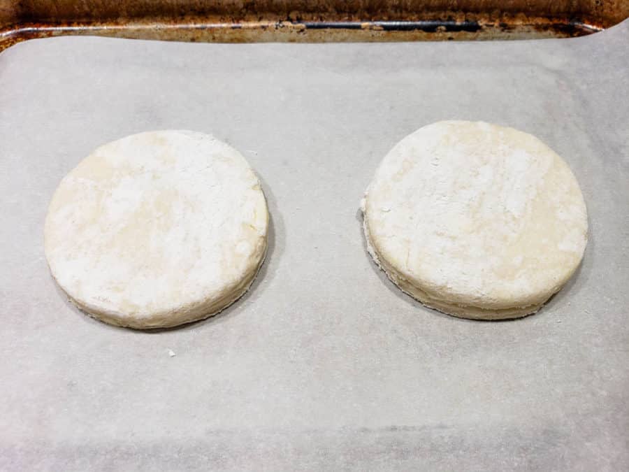 two round biscuits on a baking tray