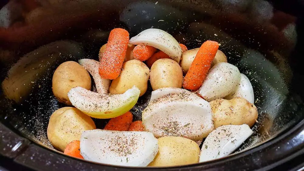 slow cooker crockpot veggies sprinkled with seasonings