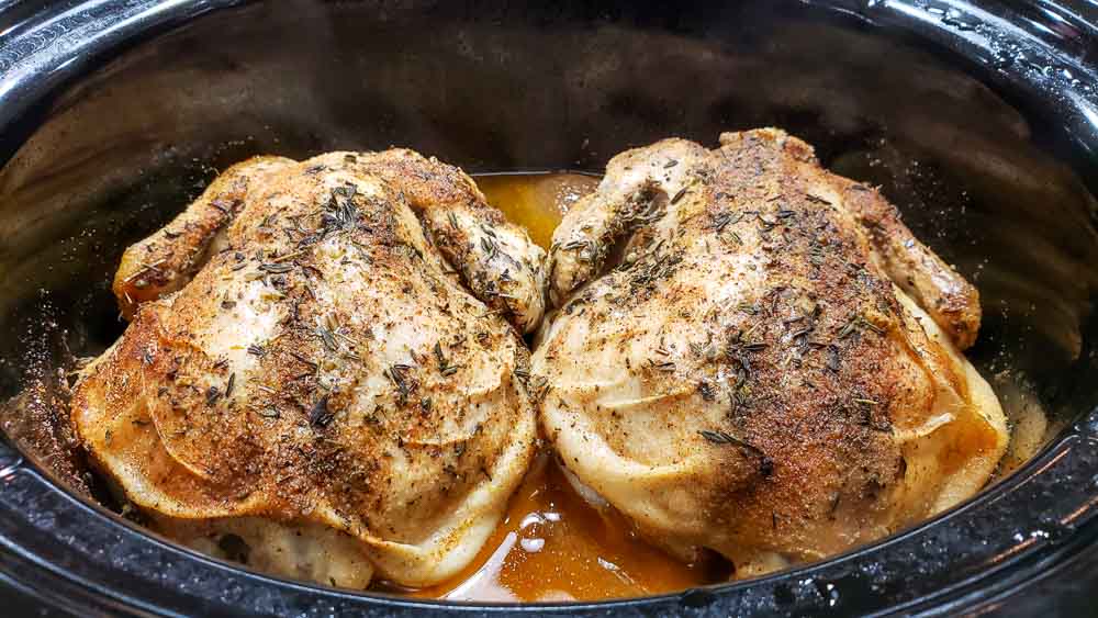 two Cornish hens in a slow cooker crock pot after cooking 8 hours
