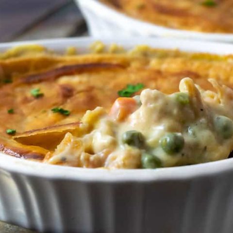 chicken pot pie with spoon lifting filling