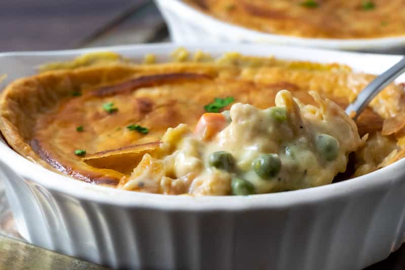 chicken pot pie with spoon lifting some out.