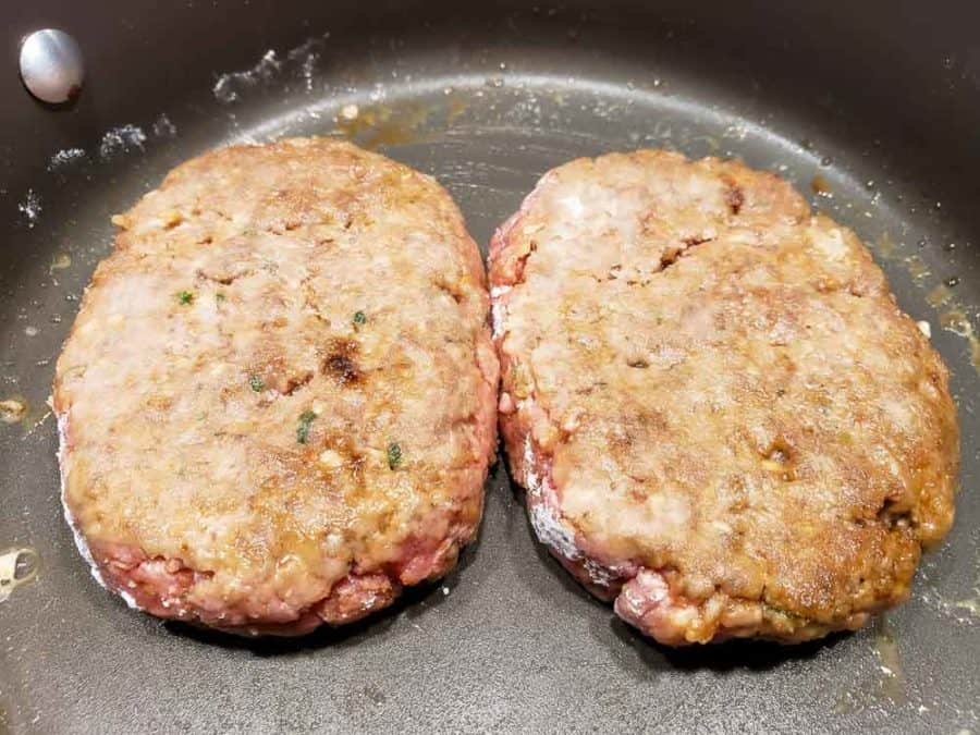 salisbury steak patties frying in a pan