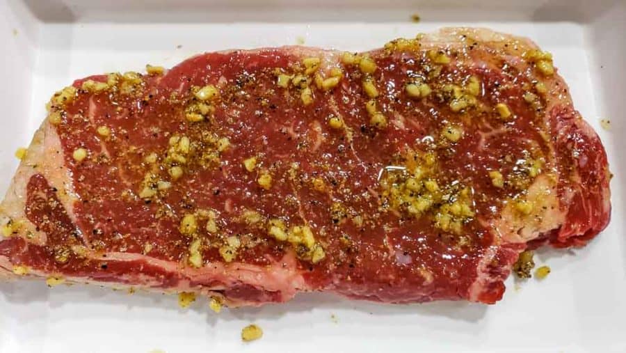 garlic mixture rubbed on a steak