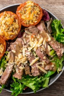 Strip Steak Salad with Broiled Parmesan Tomatoes on a plate.