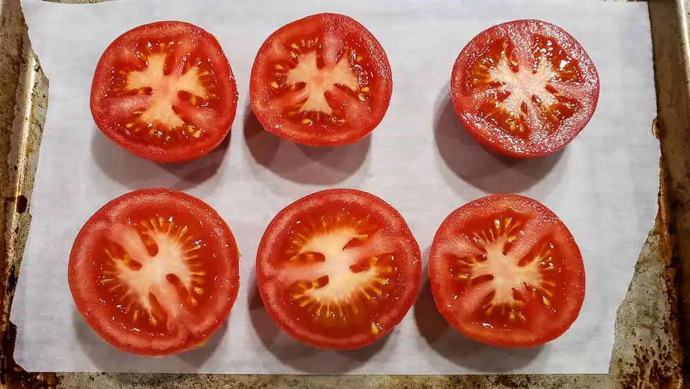 6 half tomatoes on a baking sheet