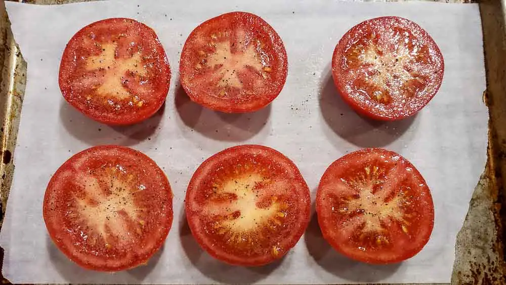 non-stick spray, salt, and pepper on 6 half tomatoes