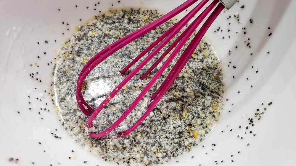 dried minced onion flakes, poppy seeds, salt, ground mustard, and mayonnaise added to dressing.
