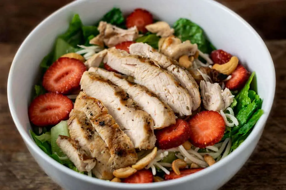 Chicken Strawberry Salad and Poppy Seed Dressing in a bowl.