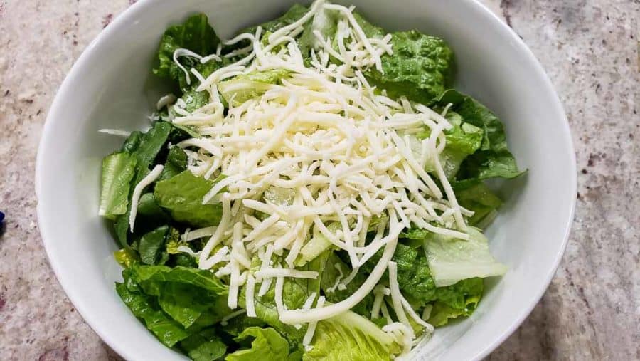 shredded mozzarella sprinkled over romaine lettuce