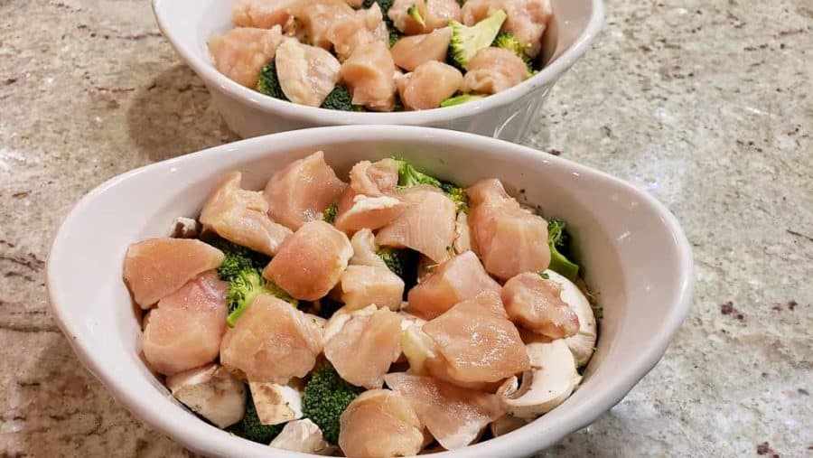 diced chicken layered over veggies in two dishes