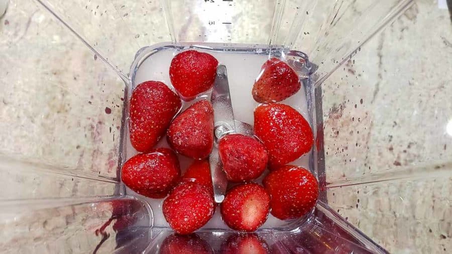 strawberries, sugar, and coconut rum in a blender