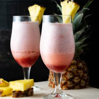 2 Hawaiian Lava Flow drinks with pineapple garnish