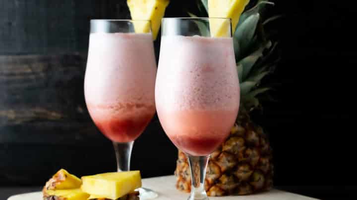 2 Hawaiian Lava Flow drinks with pineapple garnish