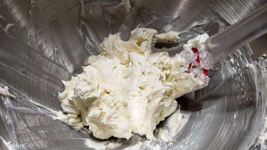 cream cheese, sugar, and vanilla mixed in a bowl with heavy cream