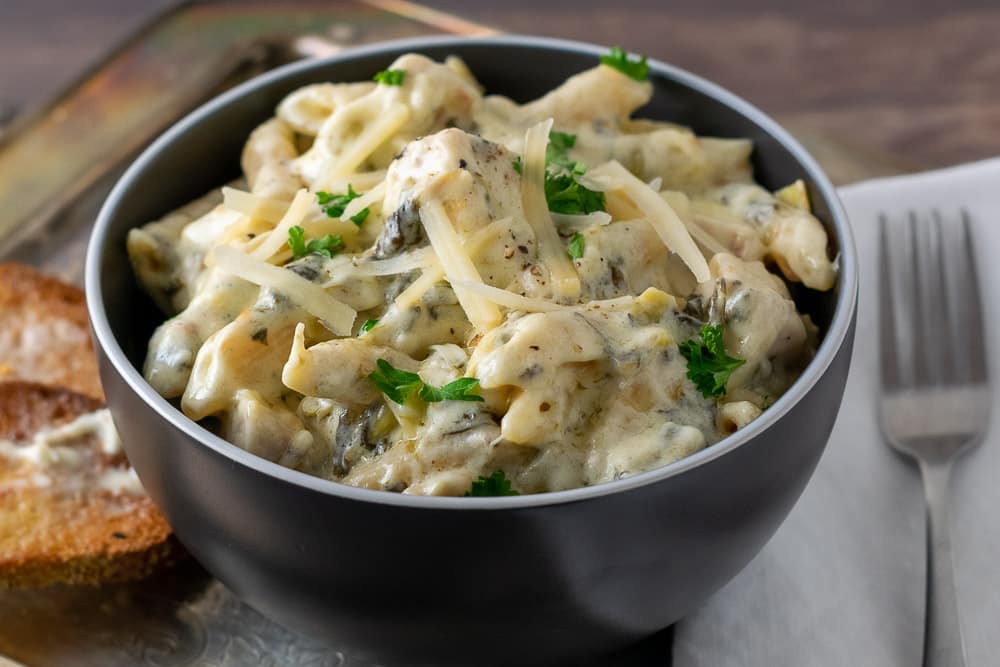 Cheesy Spinach Artichoke Chicken Pasta in a bowl