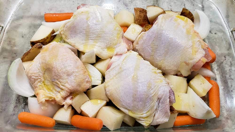 olive oil drizzled over chicken and vegetables
