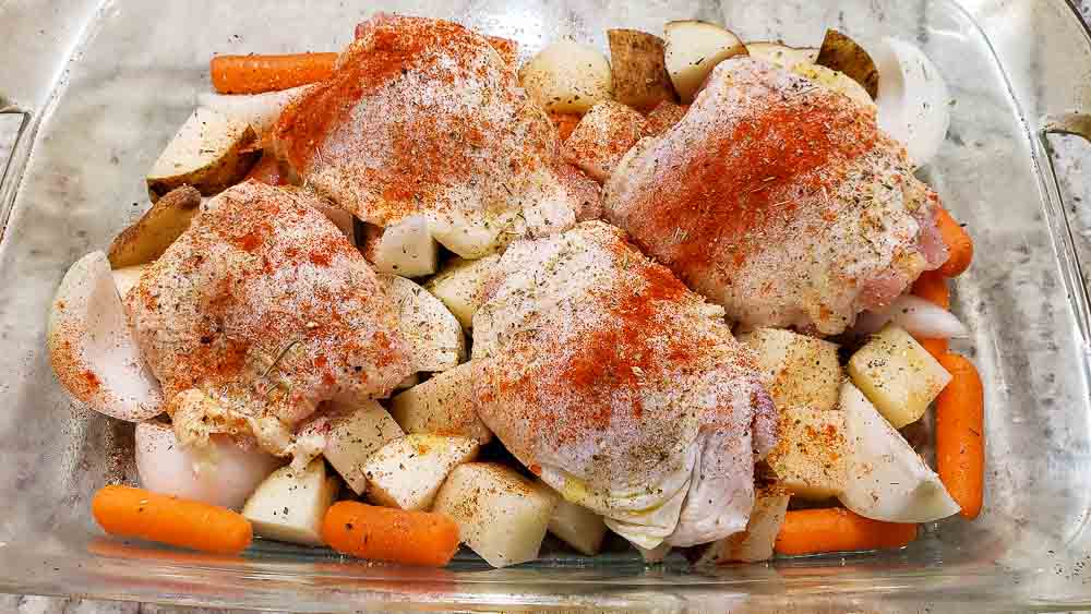 seasonings sprinkled over chicken and vegetables