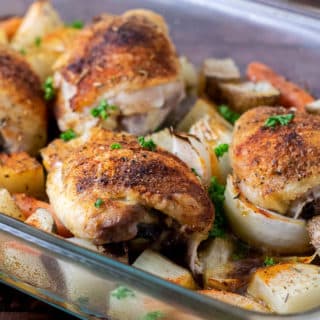 Baked Chicken Thighs with Potatoes and Carrots in a 9x13 baking dish.