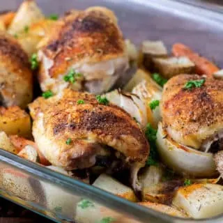 Baked Chicken Thighs with Potatoes and Carrots in a 9x13 baking dish.