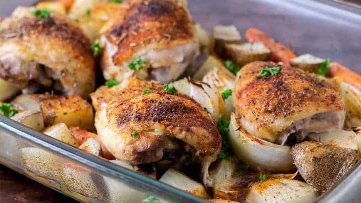 Baked Chicken Thighs with Potatoes and Carrots in a 9x13 baking dish.