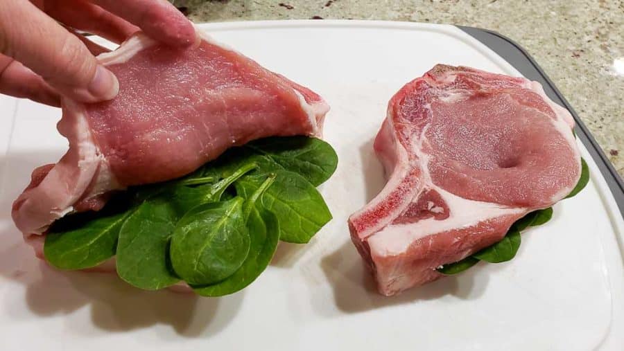 layering the spinach inside the pork chops