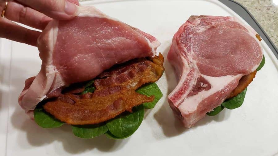 adding two bacon halves inside the pork chops