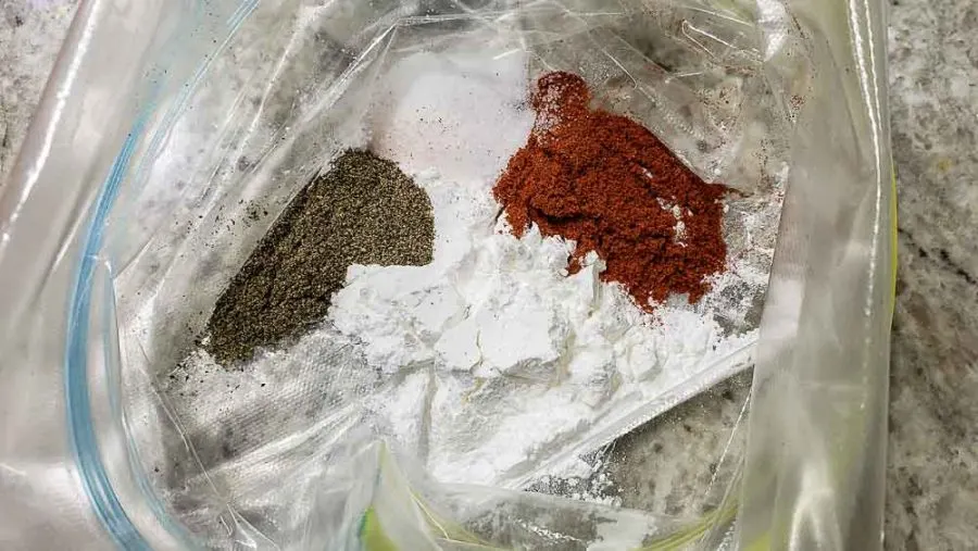 baking powder, paprika, salt, and black pepper in the bottom of a zipper baggie.