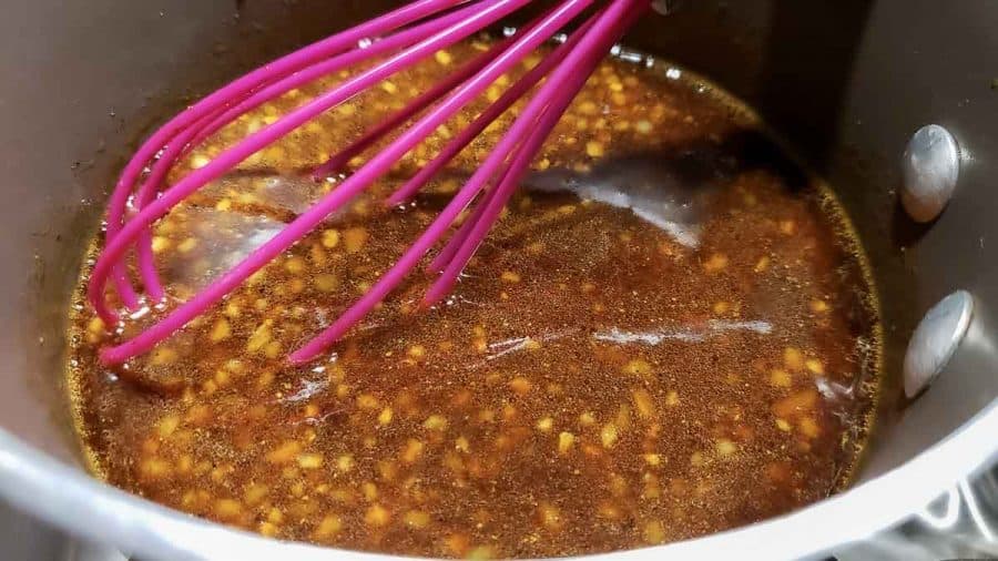 soy sauce mixture in a sauce pan with a whisk