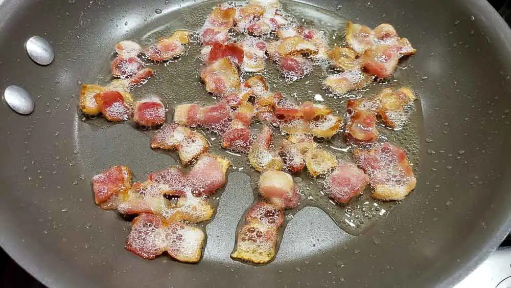 bacon crumbles cooking in a pan