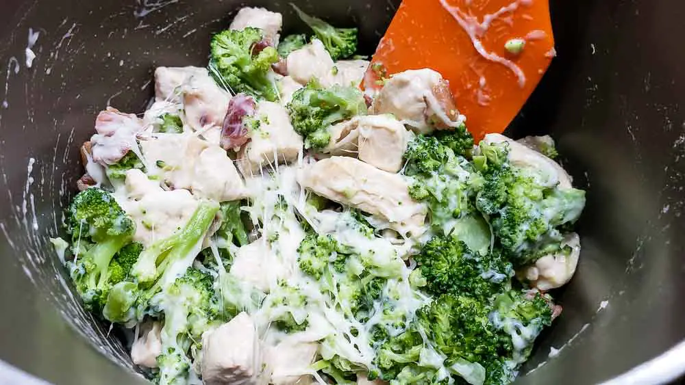 chicken, broccoli, bacon, swiss cheese added to milk mixture in a pan