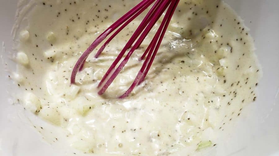 coleslaw dressing mixed in a bowl with a whisk