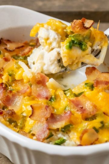 Jalape&ntilde;o Popper Chicken Casserole with a spoon lifting up some of the casserole out of the dish.