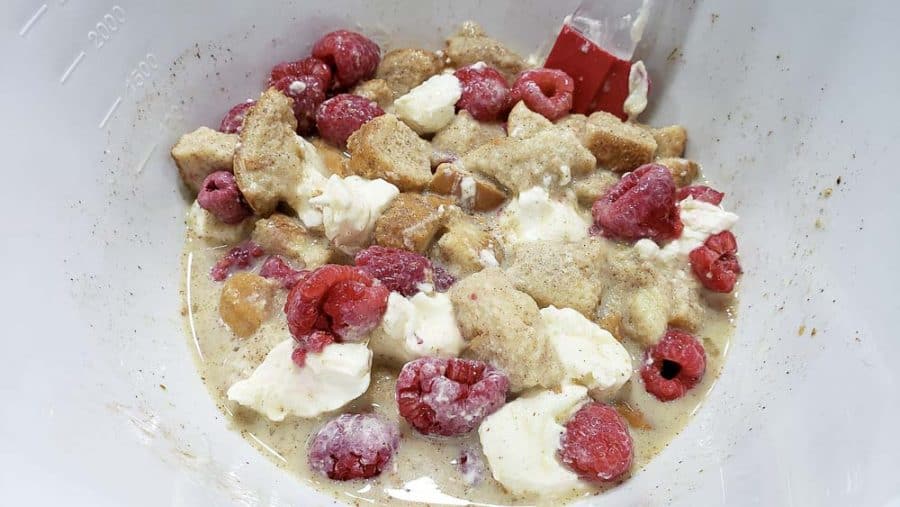 raspberries stirred into bowl with bread mixture.