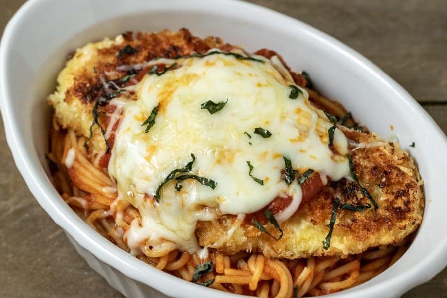 Chicken parmesan and spaghetti in a white dish