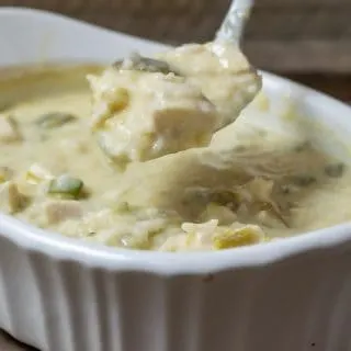 Green Chile Chicken and Rice Casserole in a dish with a spoon lifting some out