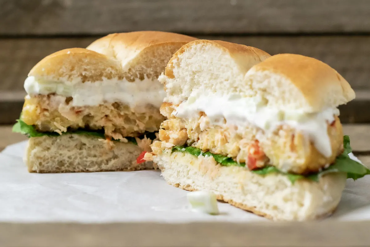 a front view of an easy salmon burger from scratch cut in half.