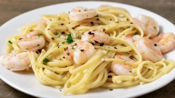 Shrimp Scampi with Linguine sprinkled with seasonings on a plate
