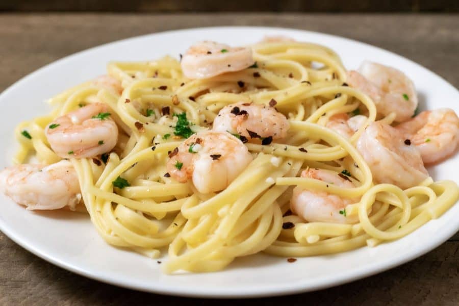 Shrimp Scampi with Linguine sprinkled with seasonings on a plate