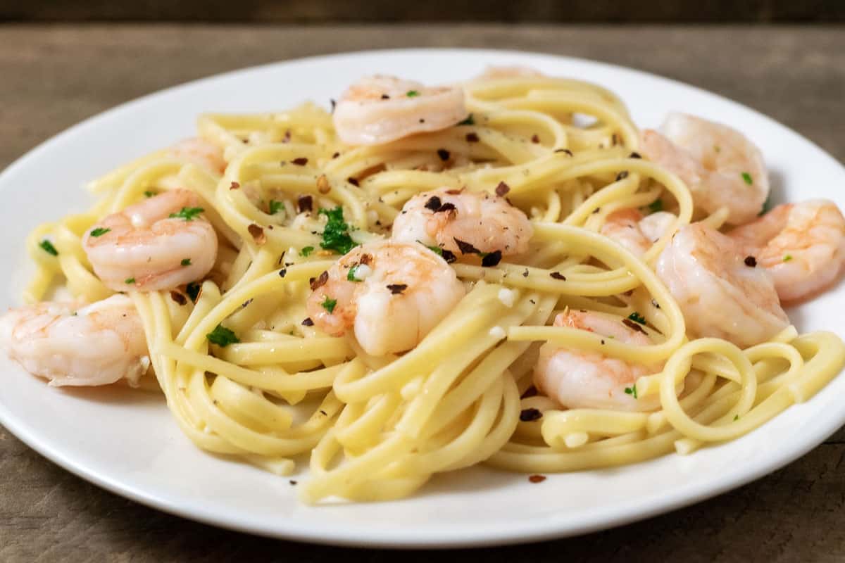 Shrimp Scampi and Pasta sprinkled with seasonings on a plate