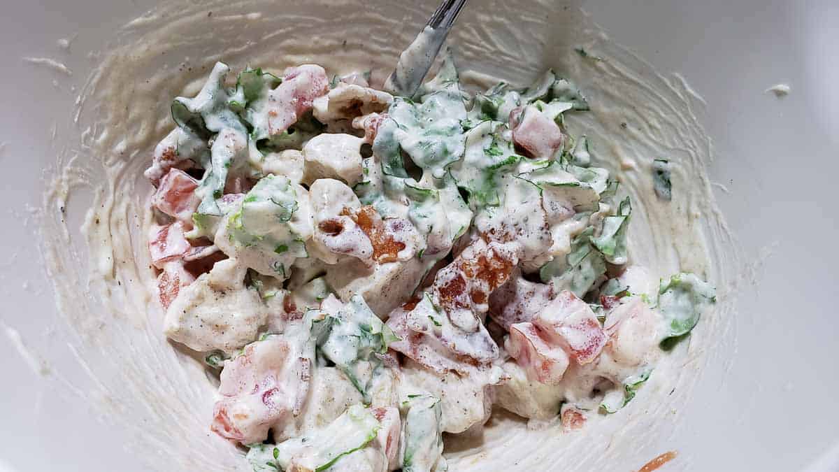 Chicken Salad with Bacon Lettuce and Tomato mixed in a bowl.