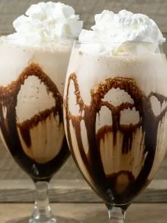 two Banana Mocha Frappe drinks topped with whipped cream