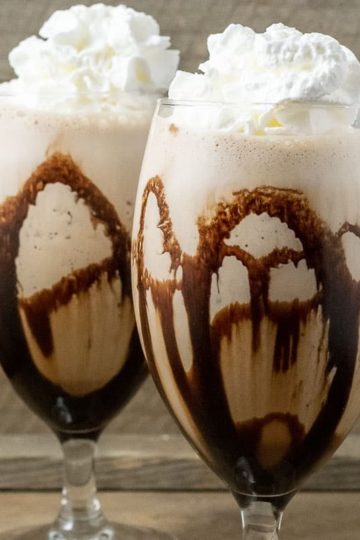 two Banana Mocha Frappe drinks topped with whipped cream