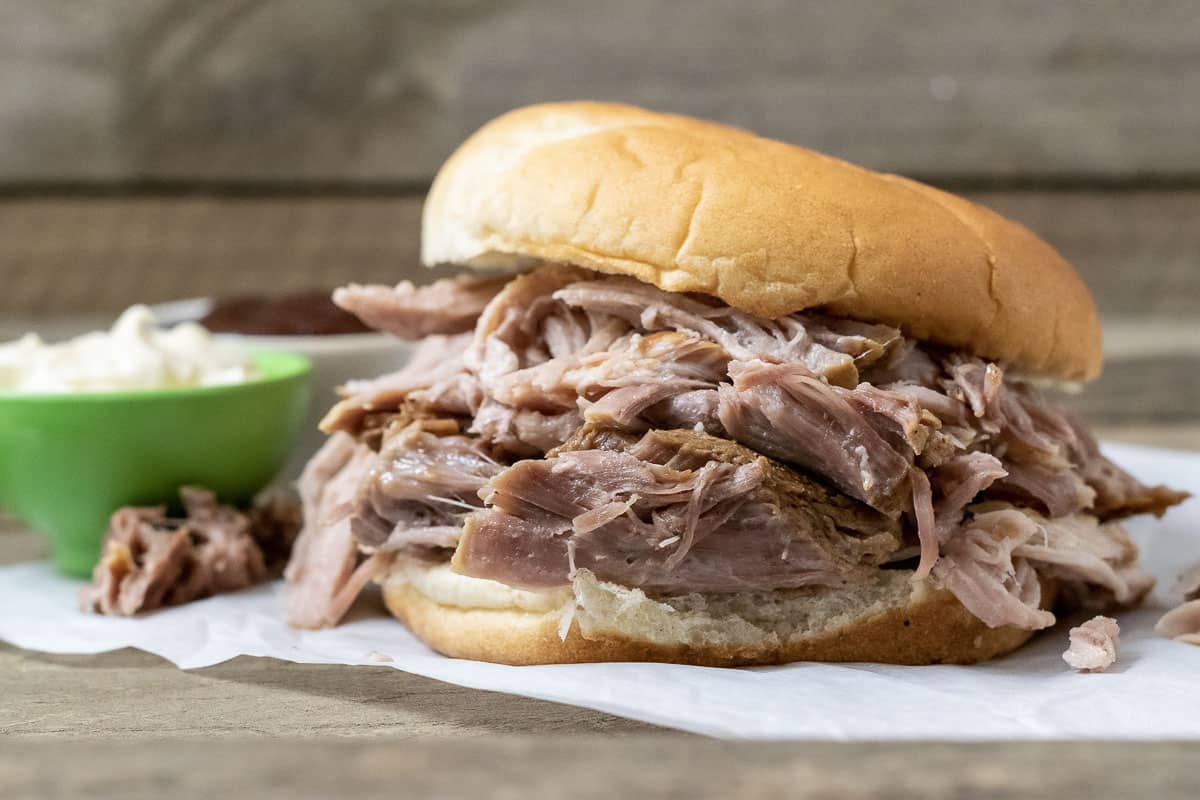 front view of a sandwich filled with Crock Pot Smoky Pulled Pork