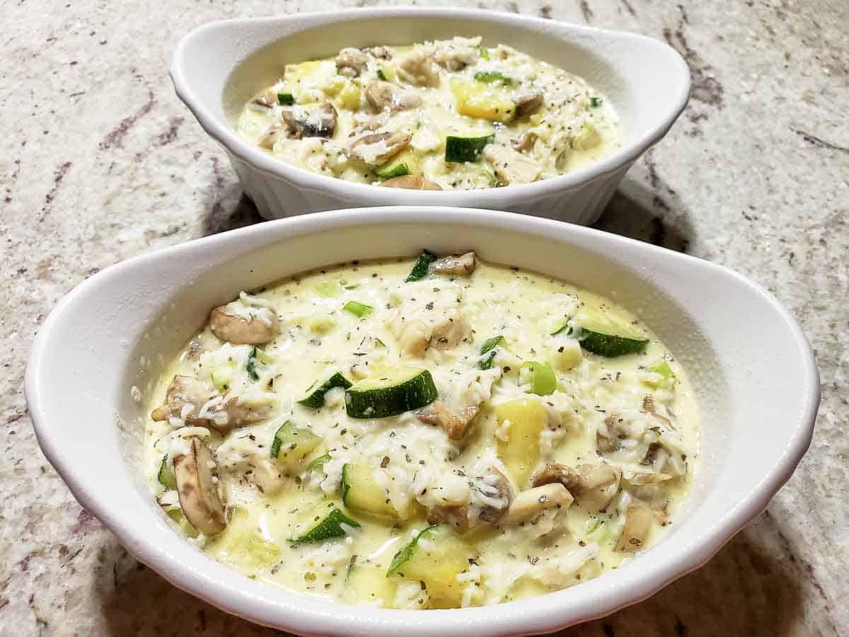 Low Carb Chicken Zucchini Casserole ready to bake in two casserole dishes.