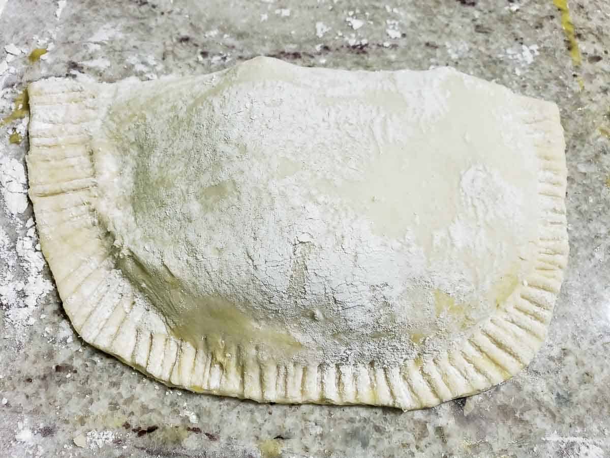 Puff Pastry Pizza Pockets with the edges rounded and crimped with a fork.