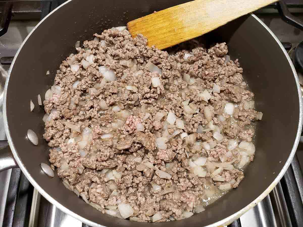 ground beef and onion cooking in a pan.