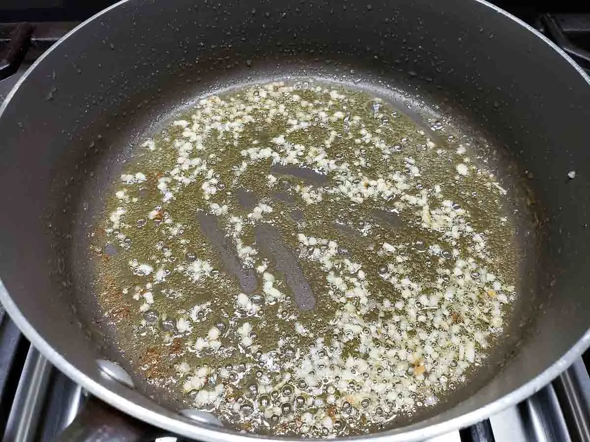 olive oil and garlic cooking in a pan.